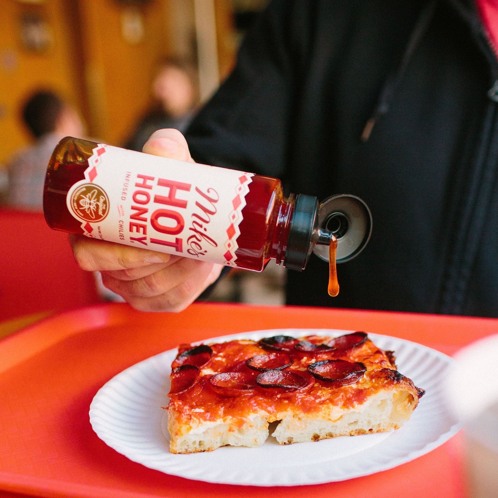 hot honey squeeze bottle with pizza